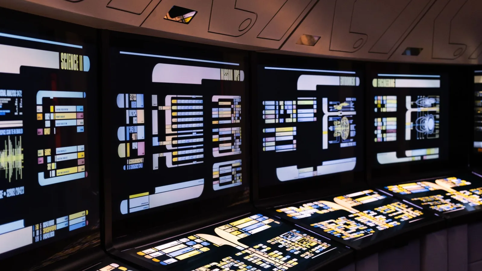 A high-tech command center with illuminated digital screens in a futuristic setting.