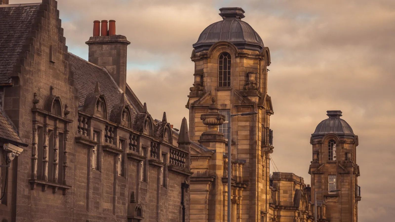 Dramatic view of old European buildings under a warm sunset sky.