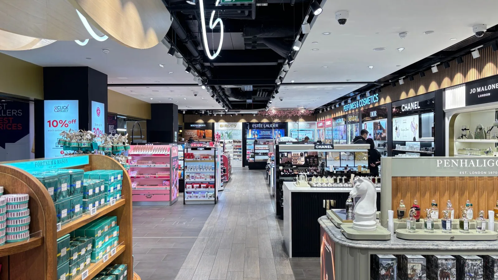 Bright cosmetics store interior showcasing luxury brands in London. Sleek and modern retail design.