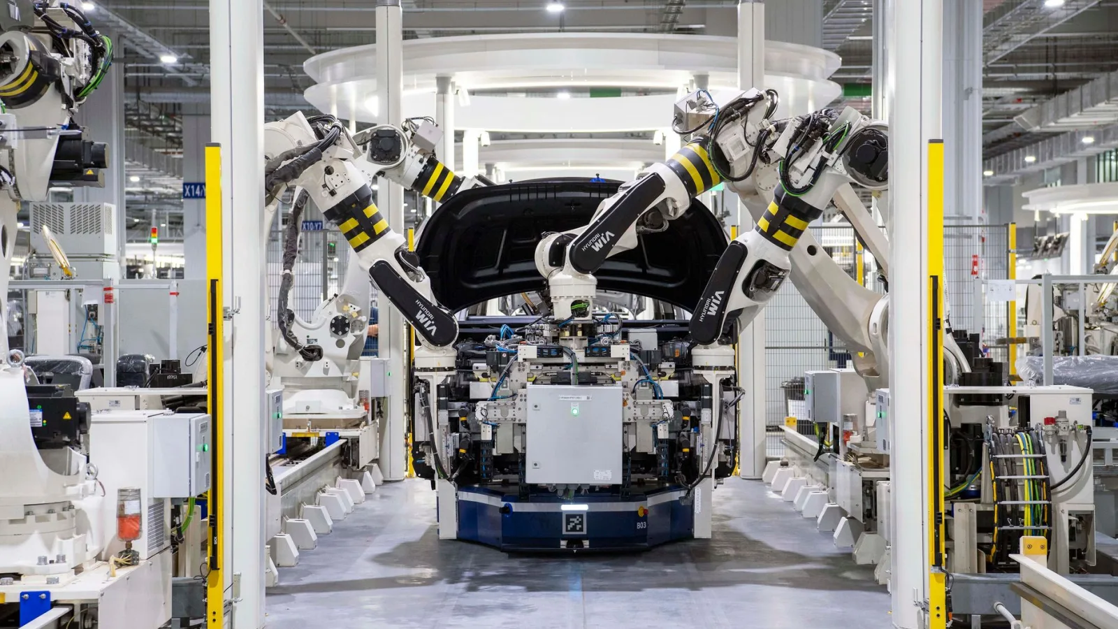 High-tech robots assembling a car in a modern factory setting, showcasing automation.