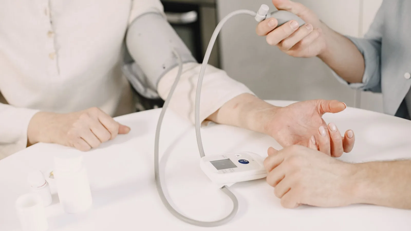 Close-up of blood pressure measurement at home highlighting healthcare equipment.