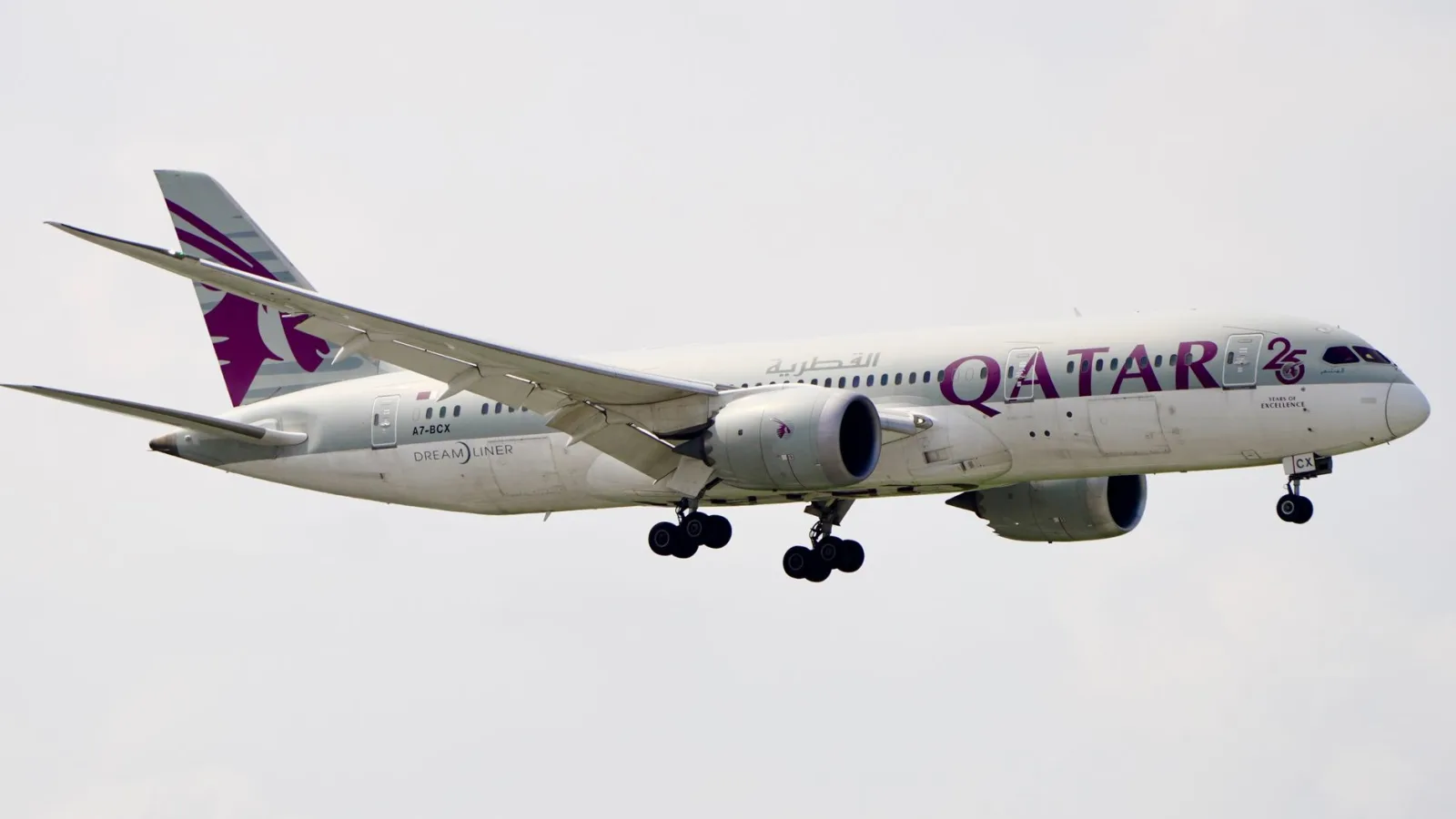 Qatar Airways Boeing 787-9 Dreamliner in mid-air, captured during daytime.