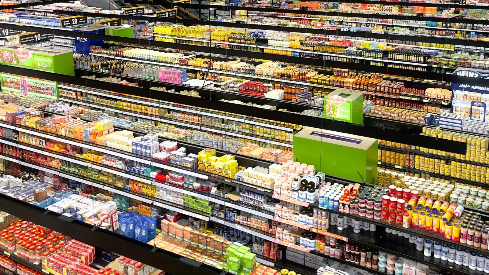 Aerial view of supermarket aisles filled with colorful products and packaging.