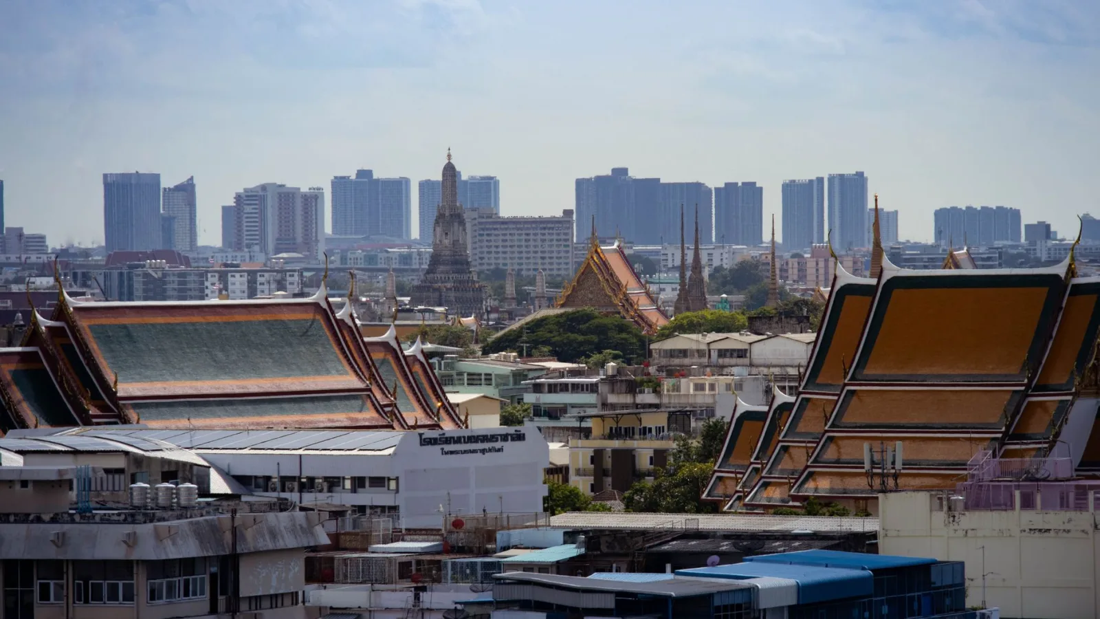 Skyline view of Bangkok highlighting traditional Thai architecture amidst modern buildings.