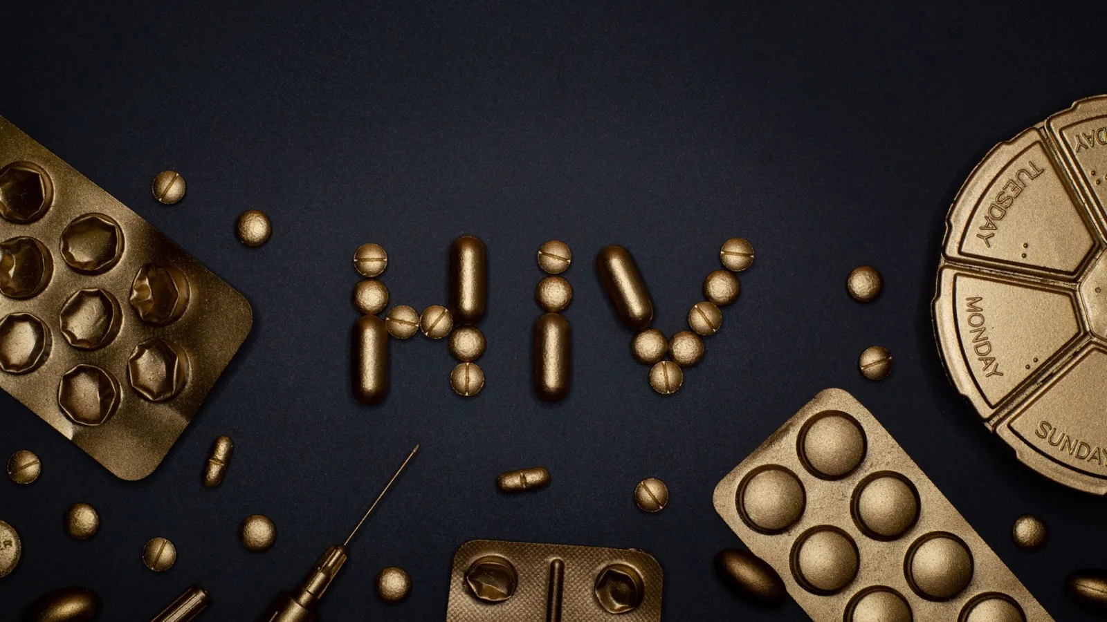 Artistic depiction of HIV with golden pills and syringes on dark background.